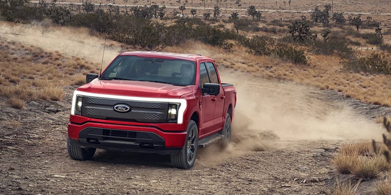 red Ford F-150 Lightning running offroading in desert