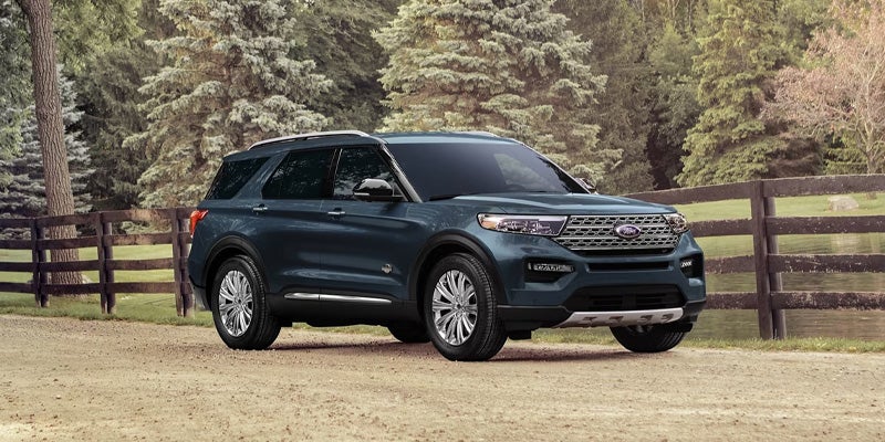 Blue 2024 Ford Explorer standing in garden area